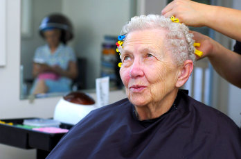 senior woman getting a haircut