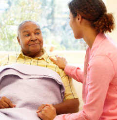 caregiver talking to senior man