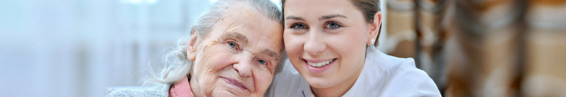senior woman and caregiver are smiling